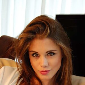 Femme brune avec poitrine genereuse regardant camera Annonay cheveux ondules